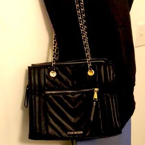 Steve Madden black purse with gold chain straps and STEVE MADDEN LOGO on bag